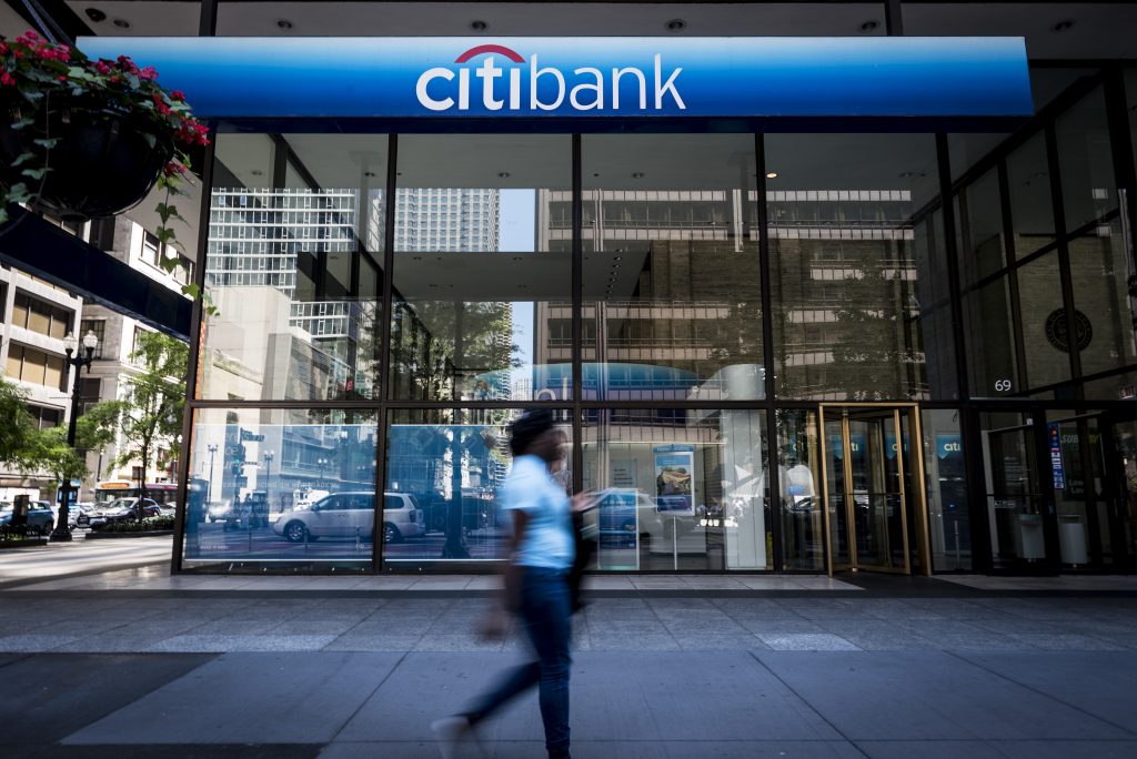 A  lady walks past a Citibank branch