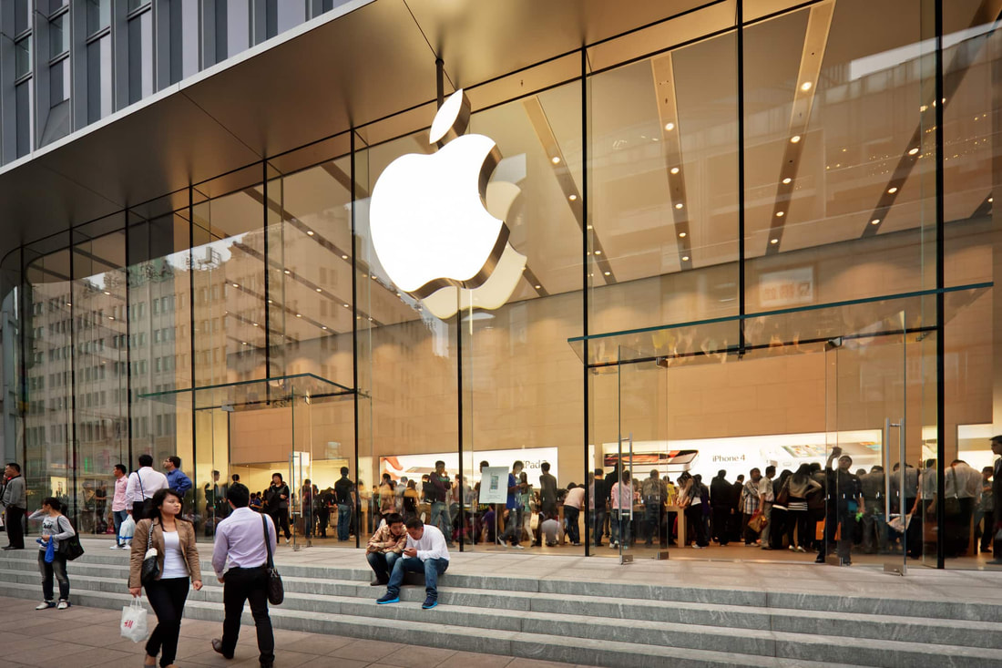 People inside and outside a Apple store. We take a look at the groups latest earnings numbers