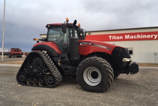 2018 CASE IH 380 MAGNUM TRACK standing in front of a Titan Machinery warehouse